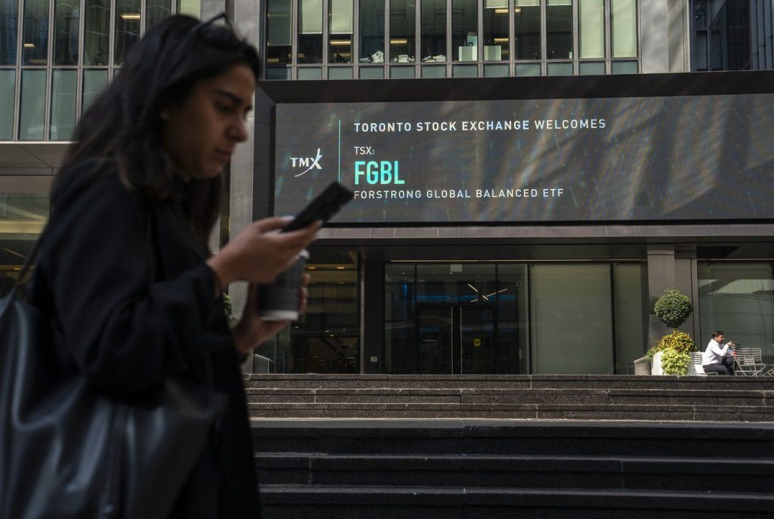 A person walks past the TMX Market Centre in Toronto
