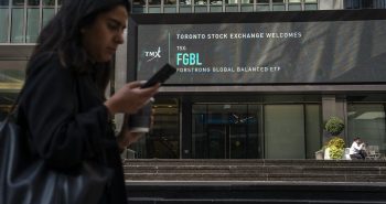 A person walks past the TMX Market Centre in Toronto