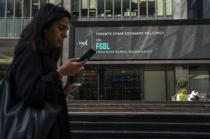 A person walks past the TMX Market Centre in Toronto