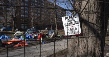 A sign advocating for support for the homeless is seen through a fenced-in homeless encampment in Victoria Park in Halifax's downtown on March 4, 2024. THE CANADIAN PRESS/Darren Calabrese Nova Scotia election promises